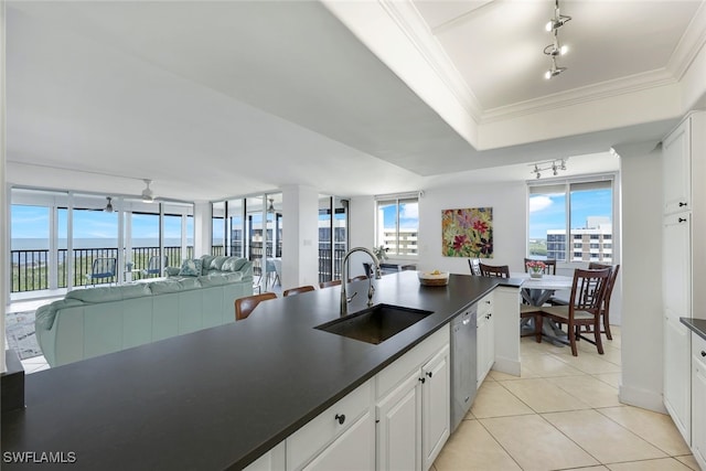 kitchen with crown molding, dishwasher, sink, and white cabinets