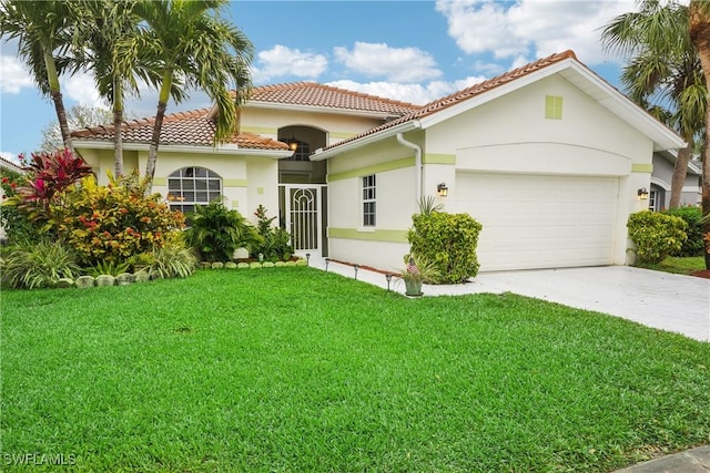 mediterranean / spanish house with a garage and a front yard