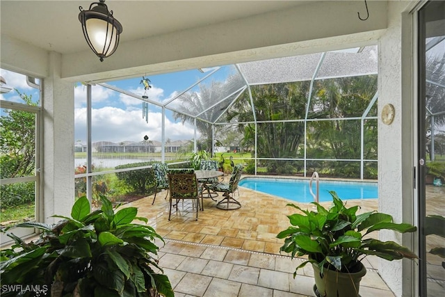 view of pool featuring a water view, a lanai, and a patio