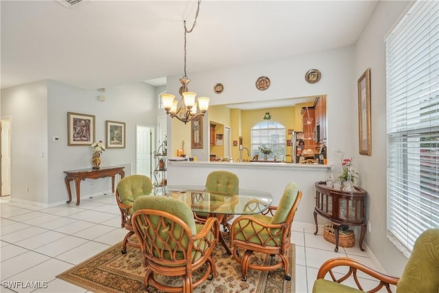 dining space with a chandelier and light tile patterned flooring