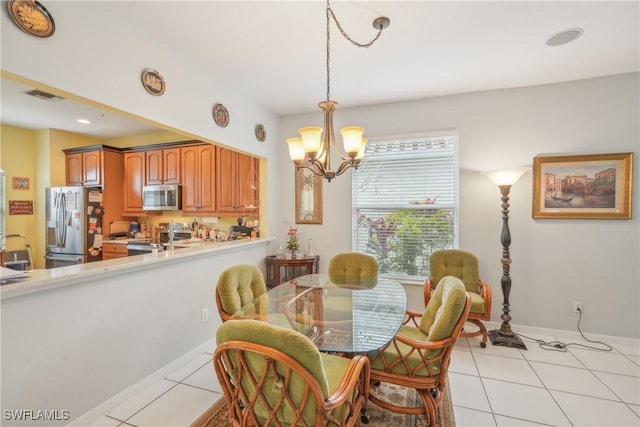 dining space with light tile patterned floors and a notable chandelier