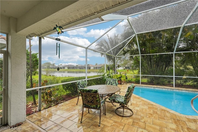 view of pool featuring a patio, a water view, and a lanai