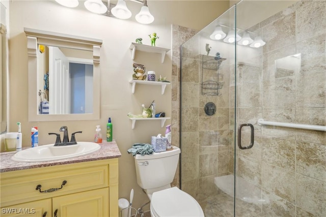 bathroom with vanity, toilet, and walk in shower