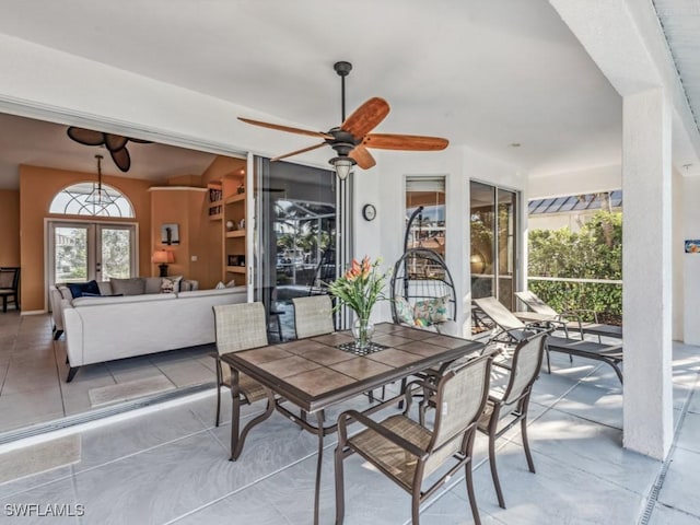 dining area featuring ceiling fan and french doors