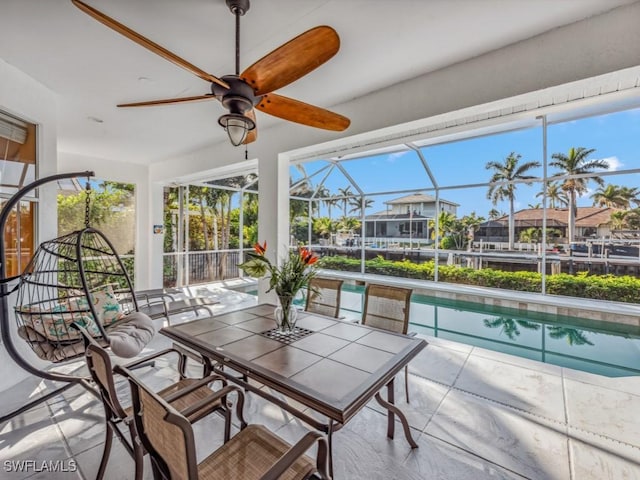 sunroom / solarium featuring a pool and ceiling fan