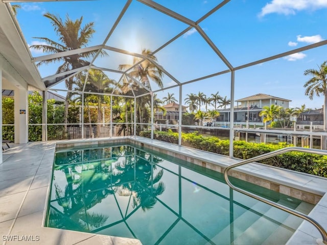 view of pool featuring glass enclosure and a patio area