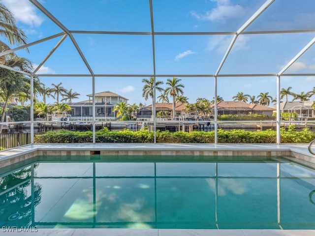 view of swimming pool featuring a lanai