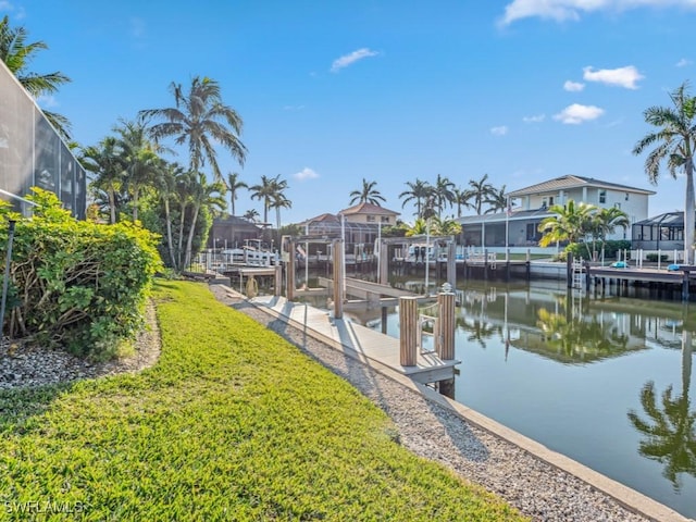 dock area with a yard and a water view