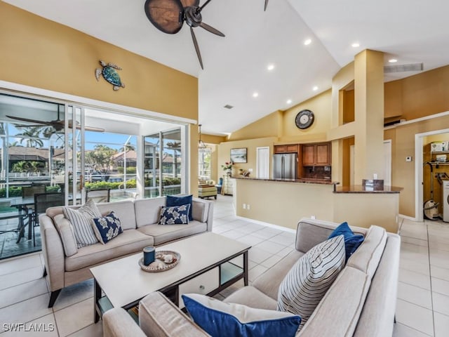 tiled living room featuring ceiling fan and high vaulted ceiling