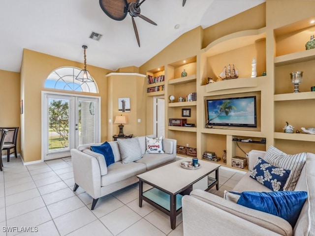 living room featuring french doors, built in shelves, vaulted ceiling, ceiling fan, and light tile patterned flooring