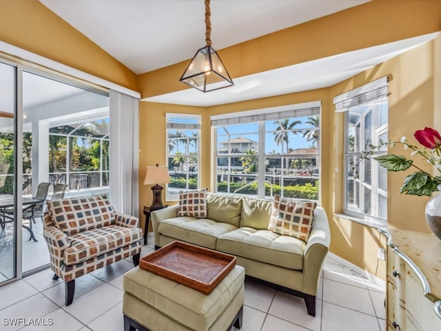 sunroom / solarium featuring a healthy amount of sunlight and vaulted ceiling