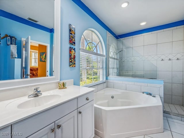 bathroom featuring tile patterned flooring, vanity, and separate shower and tub