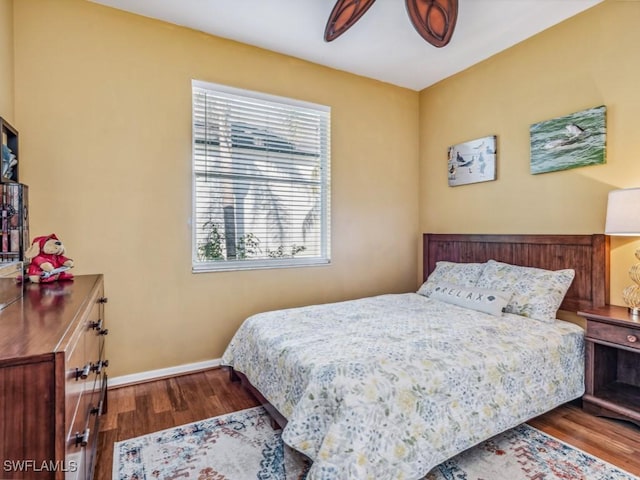 bedroom with hardwood / wood-style floors, multiple windows, and ceiling fan