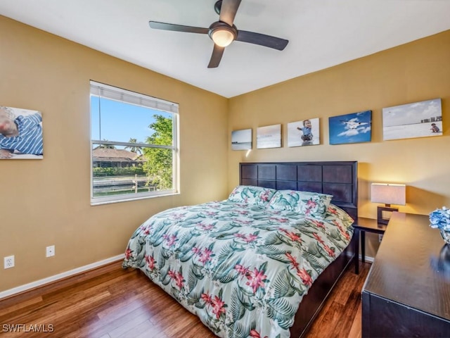 bedroom featuring ceiling fan and dark hardwood / wood-style floors