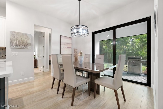 dining room with an inviting chandelier and light hardwood / wood-style floors