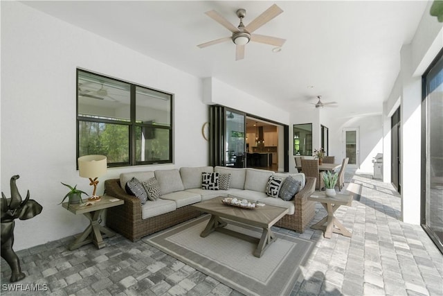 exterior space featuring ceiling fan and an outdoor living space