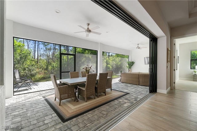 sunroom with ceiling fan