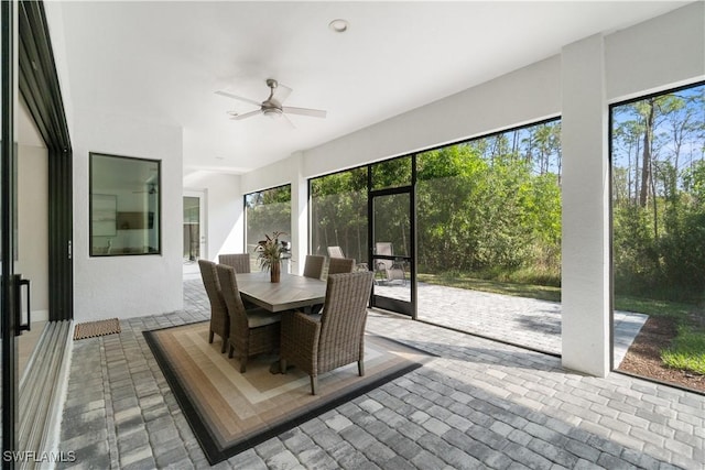 sunroom / solarium featuring ceiling fan