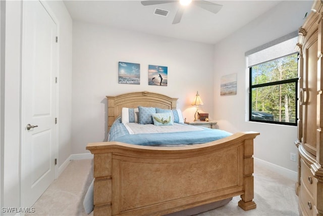 bedroom with ceiling fan and light carpet