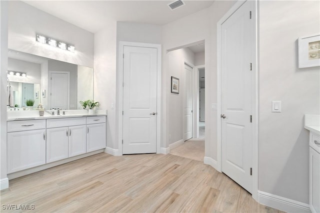 bathroom with wood-type flooring and vanity