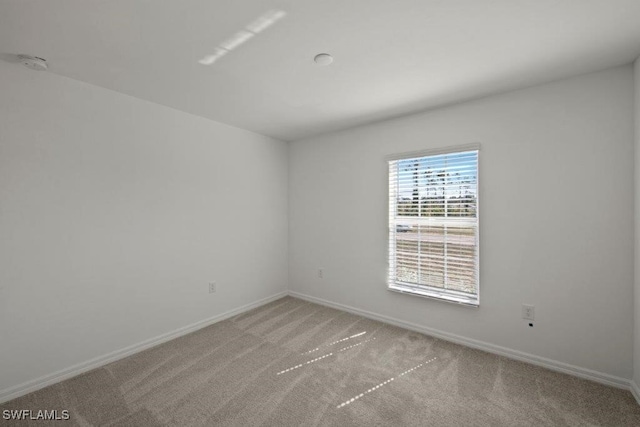 unfurnished room with light colored carpet