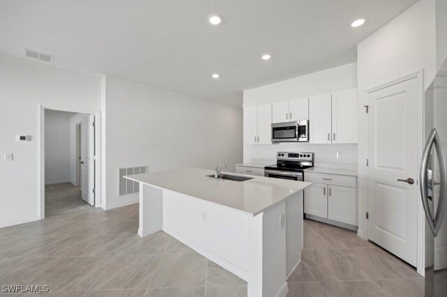 kitchen with white cabinetry, an island with sink, and appliances with stainless steel finishes