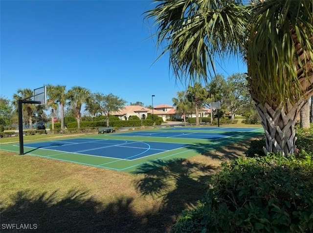 view of sport court featuring a lawn