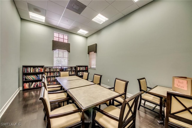 dining area featuring a paneled ceiling and dark hardwood / wood-style floors