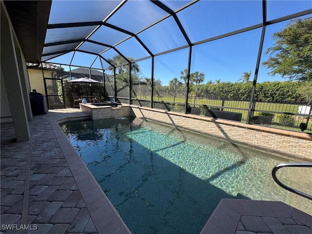 view of pool featuring a lanai, a patio, and an in ground hot tub