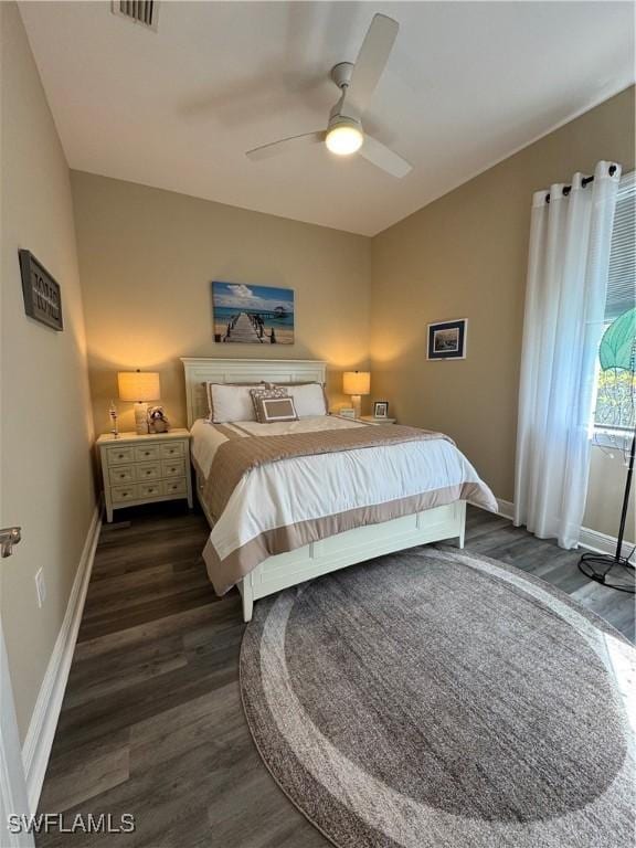 bedroom with ceiling fan and dark hardwood / wood-style floors