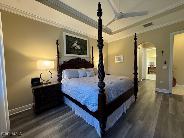 bedroom with ceiling fan, dark hardwood / wood-style flooring, and crown molding