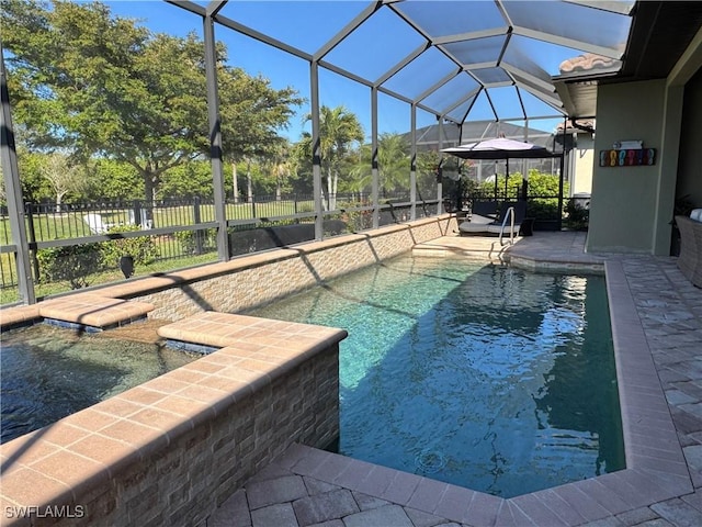 view of pool with a patio area and glass enclosure