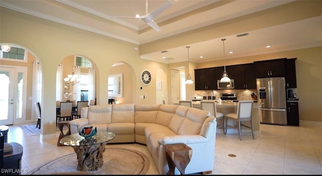 living room featuring french doors, crown molding, ceiling fan with notable chandelier, and light tile patterned floors