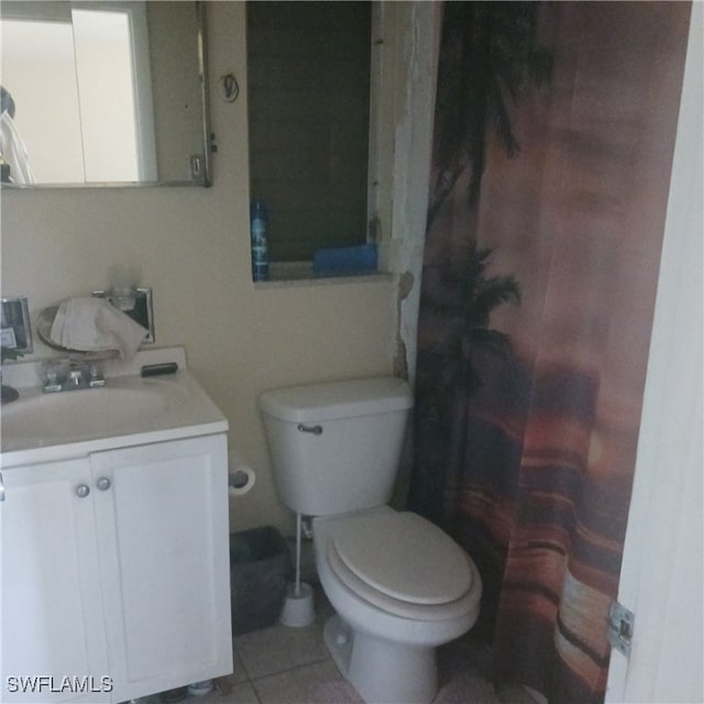 bathroom featuring tile patterned flooring, vanity, and toilet