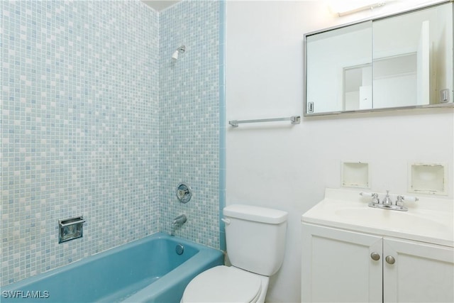 full bathroom featuring vanity, tiled shower / bath, and toilet