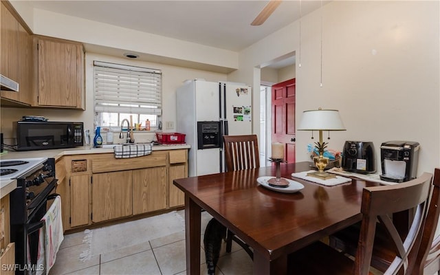 kitchen with light tile patterned flooring, ceiling fan, sink, and black appliances