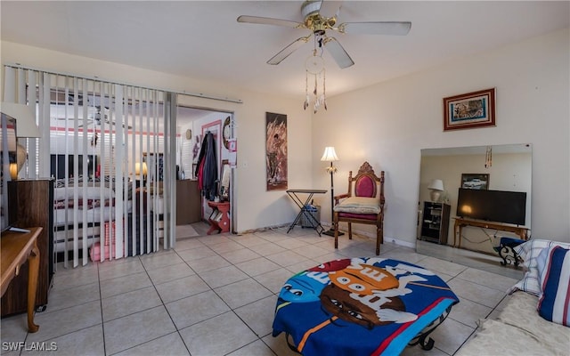 living area featuring ceiling fan and light tile patterned floors