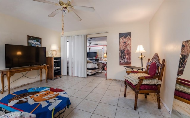 living area featuring light tile patterned floors and ceiling fan