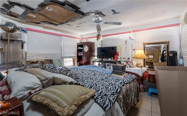 bedroom featuring a wall mounted air conditioner, light tile patterned floors, and ceiling fan