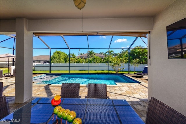 view of pool with a patio area and glass enclosure