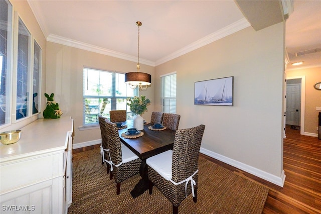 dining space with ornamental molding and dark hardwood / wood-style floors