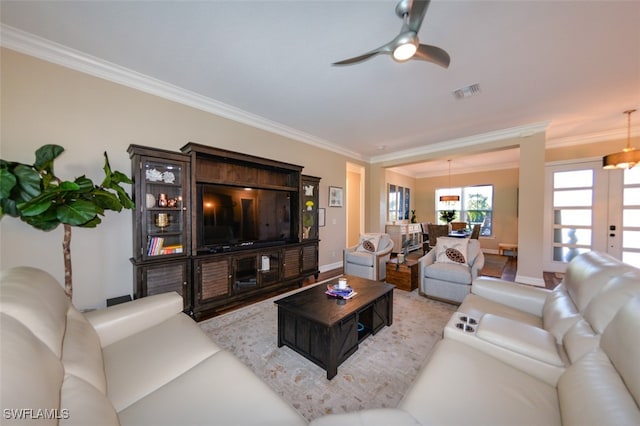 living room featuring ornamental molding and ceiling fan