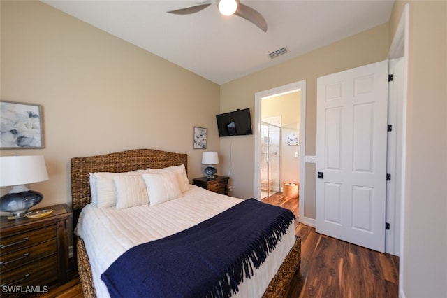 bedroom with dark hardwood / wood-style floors, ceiling fan, and ensuite bath