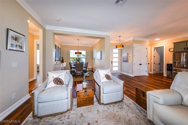 living room with ornamental molding and hardwood / wood-style floors