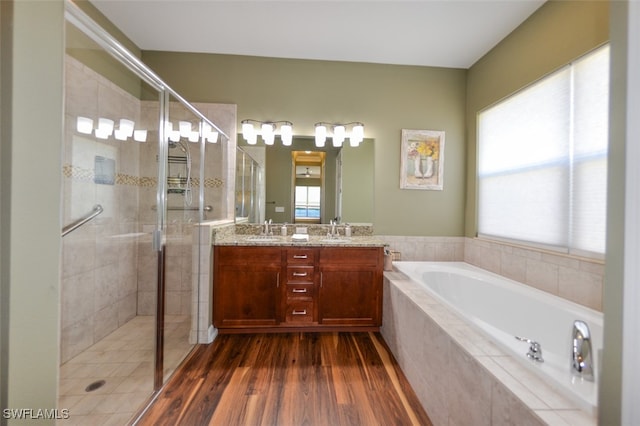 bathroom with vanity, shower with separate bathtub, and wood-type flooring