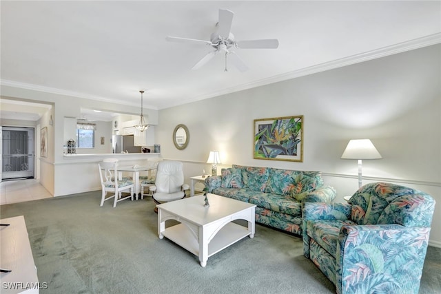 carpeted living room with ornamental molding and ceiling fan