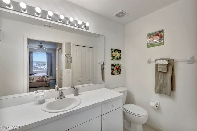 bathroom featuring ceiling fan, vanity, and toilet