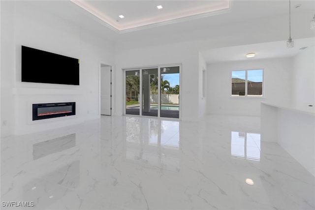 unfurnished living room featuring a tray ceiling