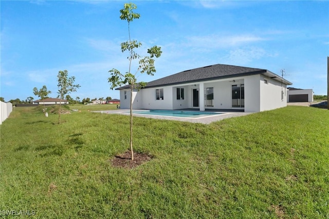 rear view of property with a yard and a patio area