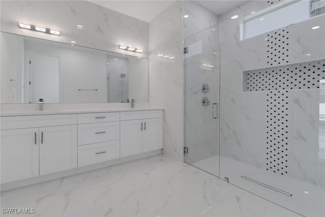 bathroom with vanity and a shower with shower door